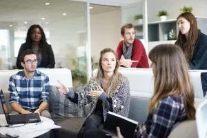 A person working with movers in order to plan a move on short notice. People in a meeting