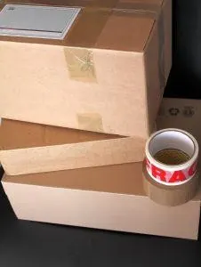 Packed boxes with tape next to them. Packed boxes