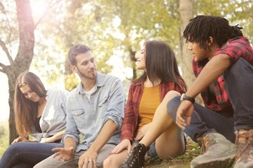 A group of people from diverse cultures smiling and enjoying each other's company.