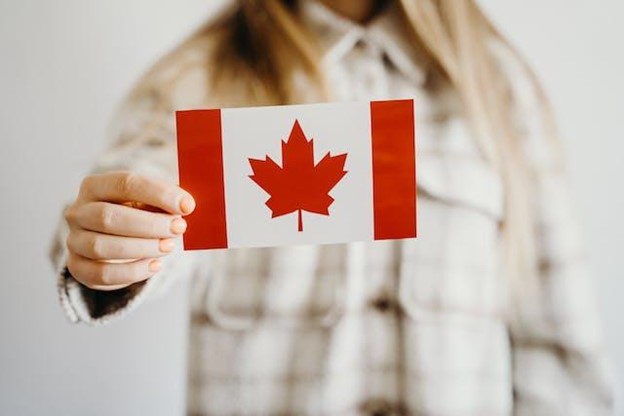 Close-up shot of a person holding the Canadian flag