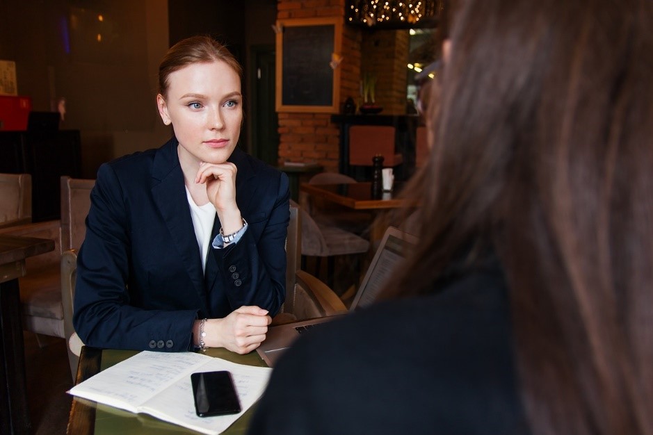 Suited woman sat at desk