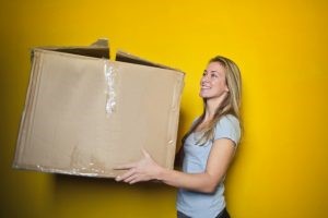 A woman holding a cardboard box