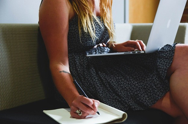 Woman writing on notepad