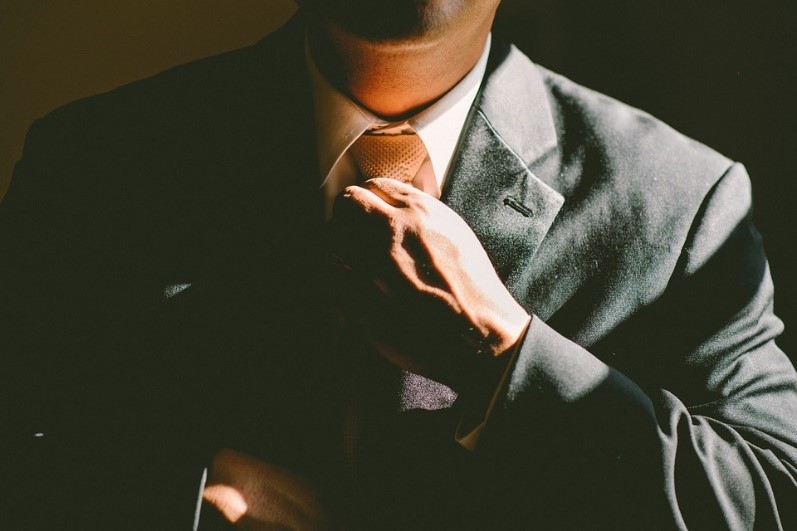 Man fixing tie