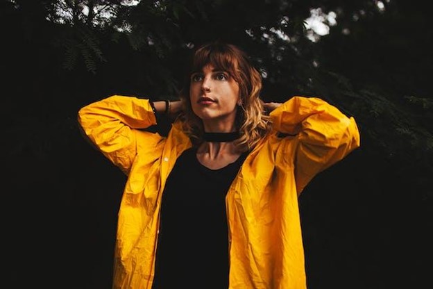A young woman in a yellow raincoat