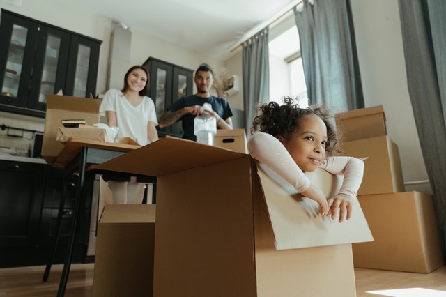 Little girl playing in a box