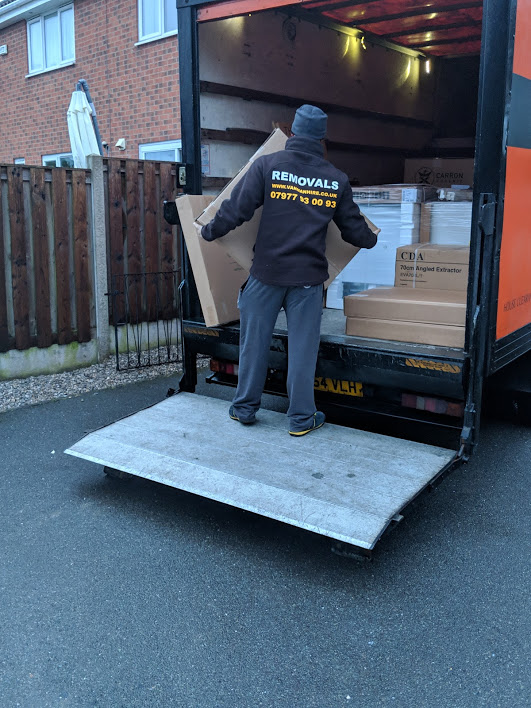 Professional movers unloading a Luton removal van during a house relocation